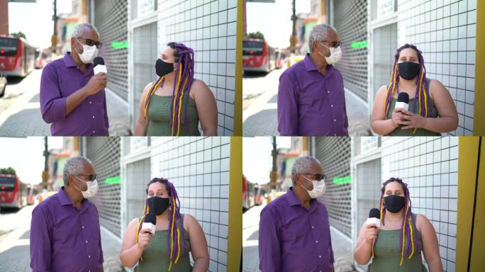 戴着口罩的电视记者在街上采访一名妇女