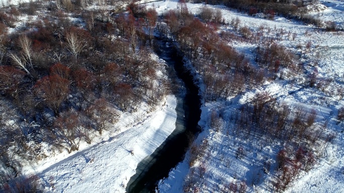 航拍冬季林海雪原冰封小河