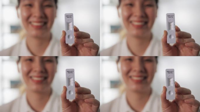 亚洲女性持有新冠肺炎冠状病毒自检试剂盒