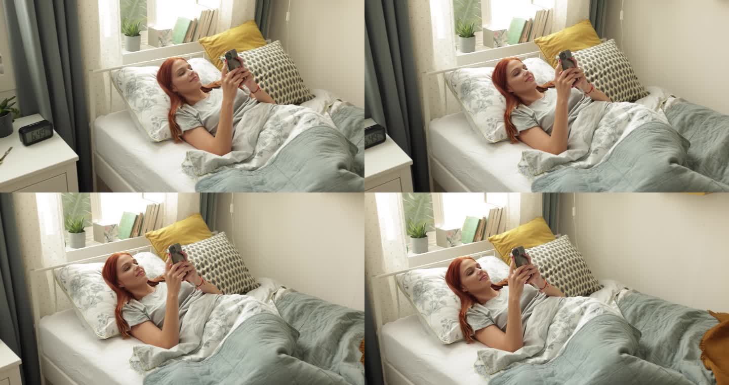 大学生宿舍床上玩手机