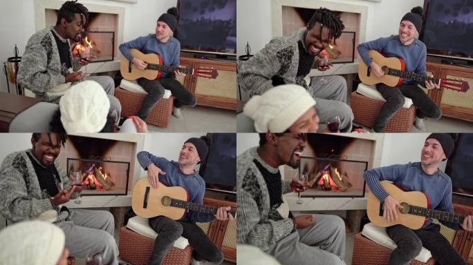 多样化的年轻朋友在壁炉边边喝酒边唱歌和弹吉他