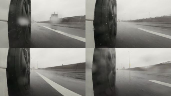 雨天在高速公路上开车。汽车轮胎和飞溅的水