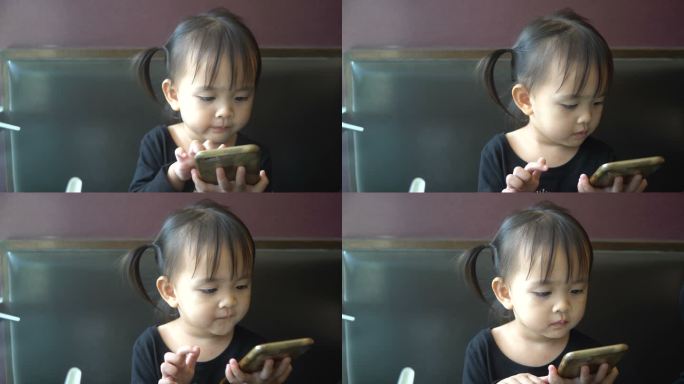 亚洲女孩在餐厅里使用电话。