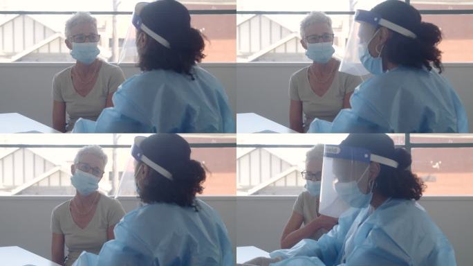 戴口罩的高级妇女与护士谈论新冠肺炎疫苗