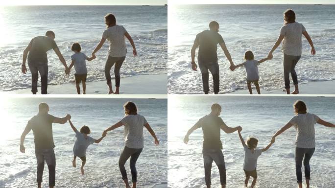 爸爸妈妈和儿子在海滩玩耍