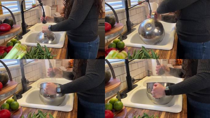 年轻女子在厨房用热水洗碗