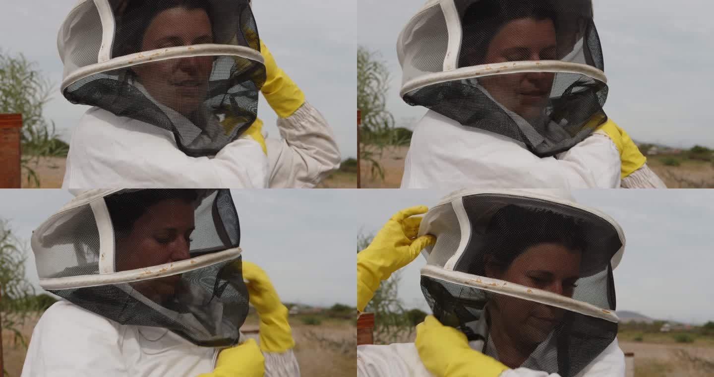 4k视频画面显示一名妇女在农场工作时穿着养蜂服