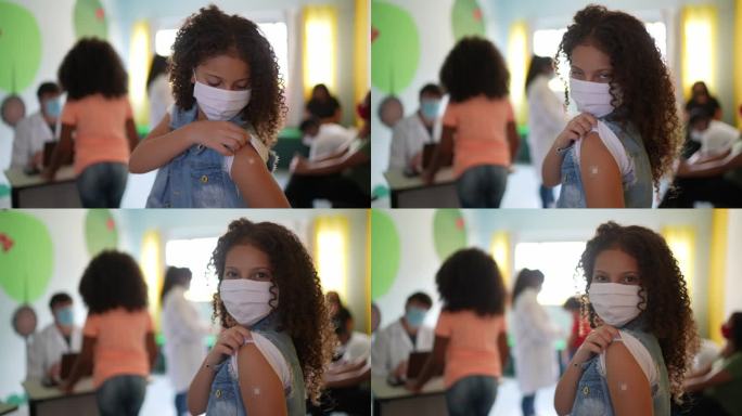 一名女孩接种疫苗后露出手臂的照片