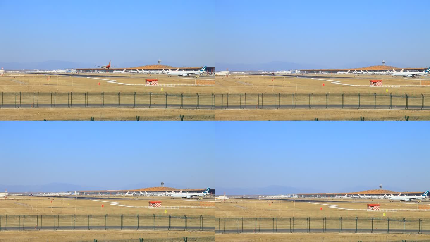 一架飞机飞过降落在飞机场内跑道上