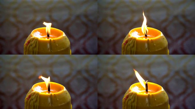 泰国寺庙中蜡烛上的火焰缓慢移动。