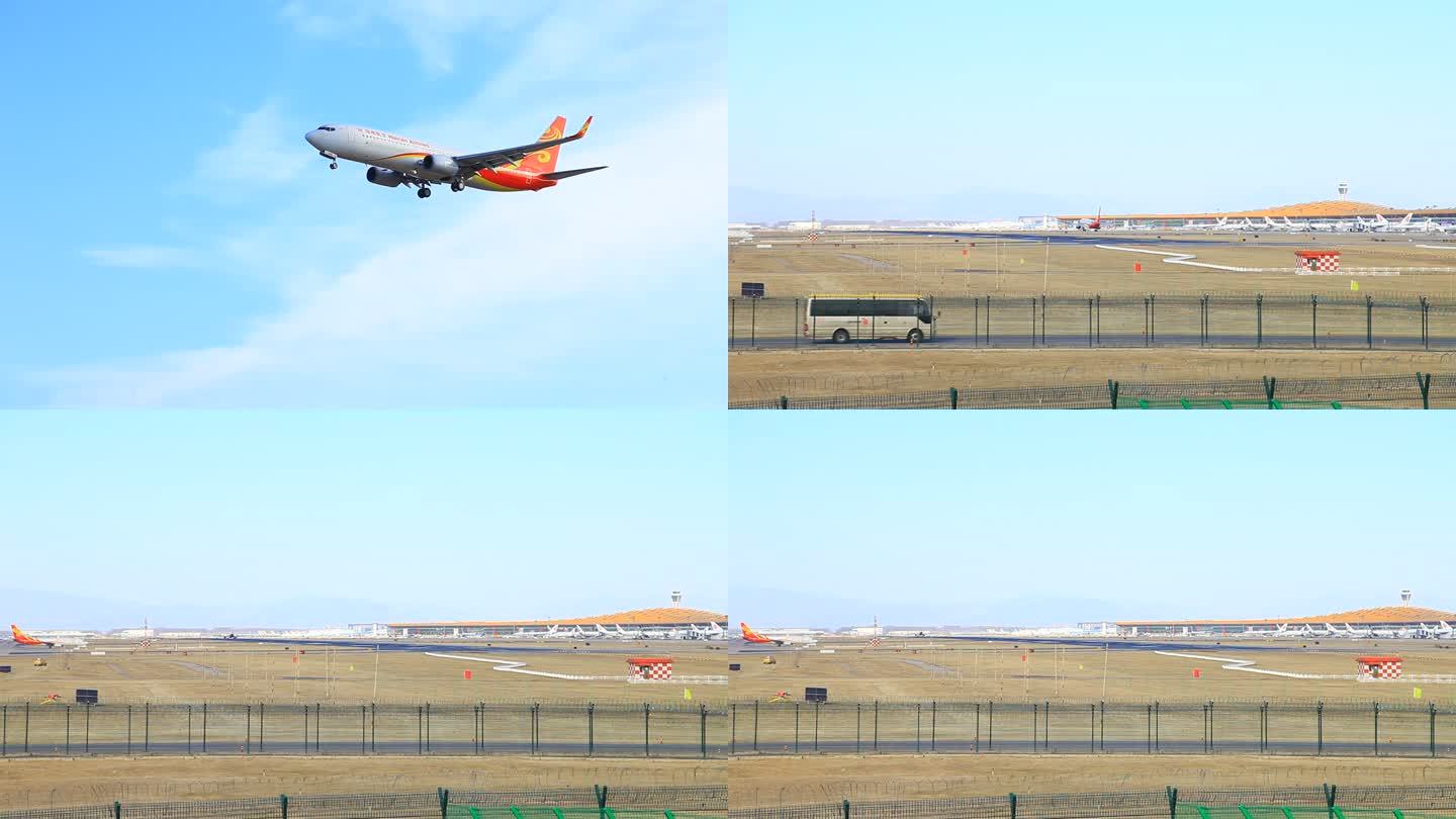 一架飞机从远处飞过又降落在飞机场内跑道上