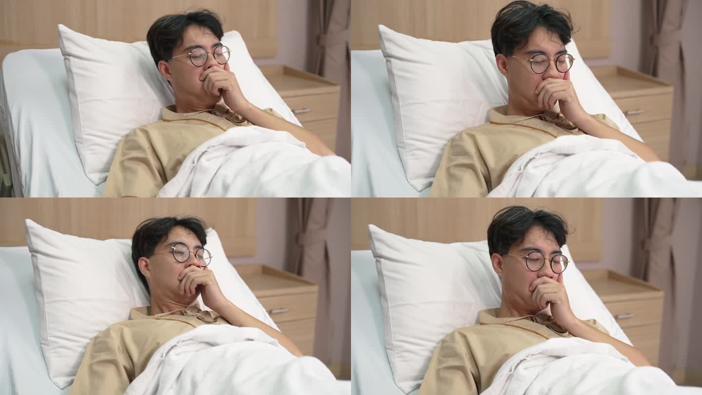 亚洲男性患者在医院休息时感到床上不舒服。