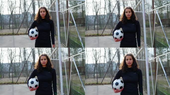 一位年轻女子足球运动员站在运动场球门柱旁的肖像