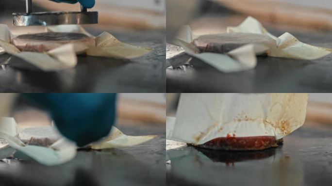 一位厨师在烤架上压平汉堡肉饼的4k视频片段