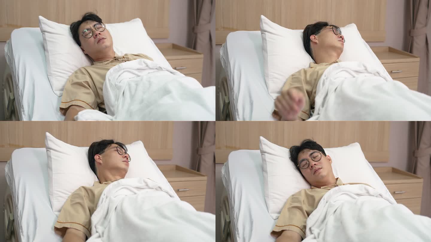 亚洲男性患者在医院休息时感到床上不舒服。