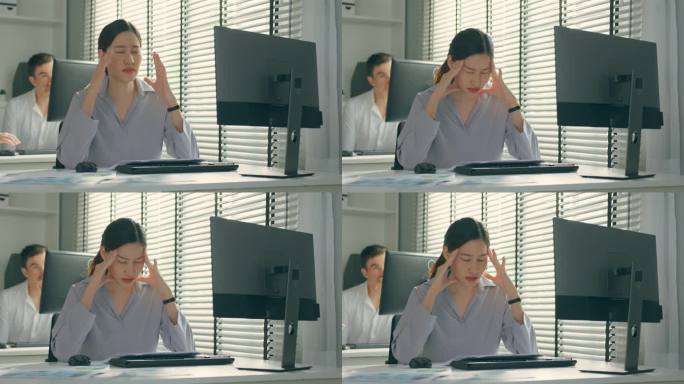 疲惫的亚洲患病商业女工在办公室的桌子上工作。忙碌的员工由于工作迟到和工作过度而感到疲倦和头痛，工作文