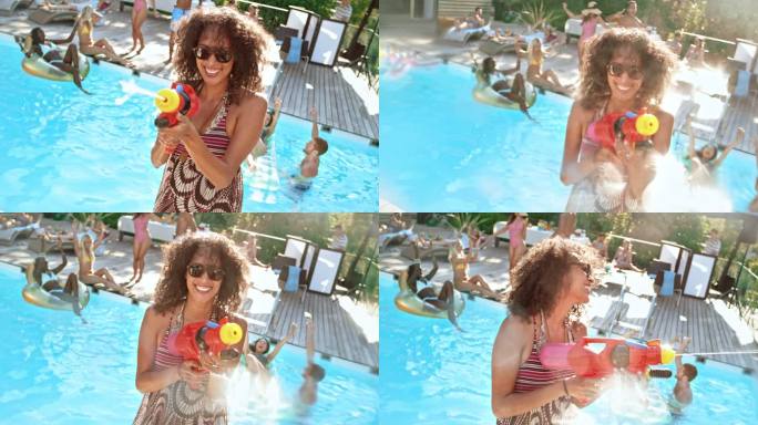 SLO MO一位戴着墨镜的女子在泳池派对上用水枪向镜头喷水