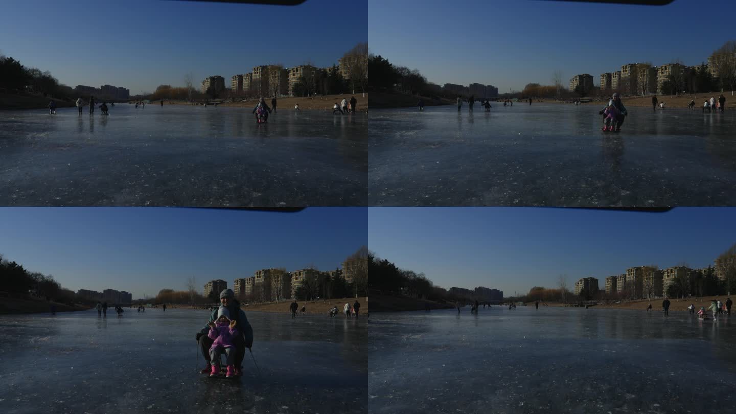 冬季冰湖上父女俩滑冰车