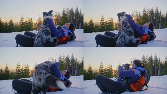 日出时分，一位年轻女子和她的狗在雪坡上拥抱