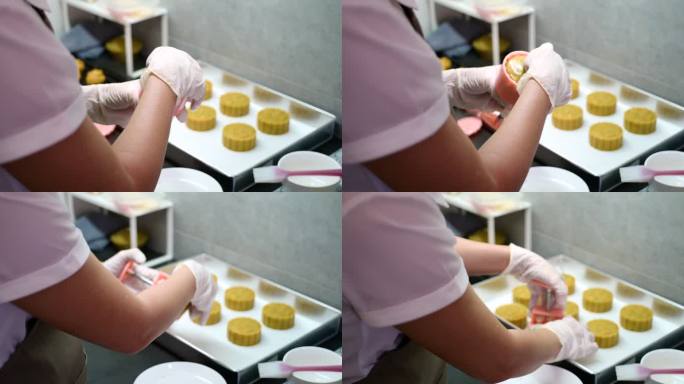 妇女在烤盘上塑造月饼糕点的形状