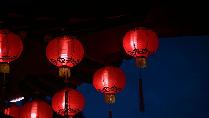 夜晚，古老的传统寺庙上挂着圆形的红色灯笼。