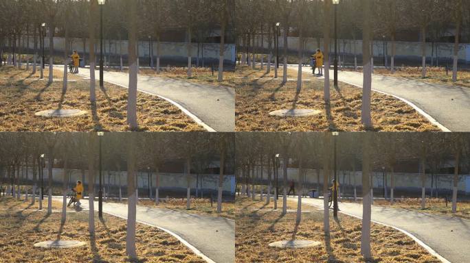 公园里一名小女孩推着自行车半路把车停靠
