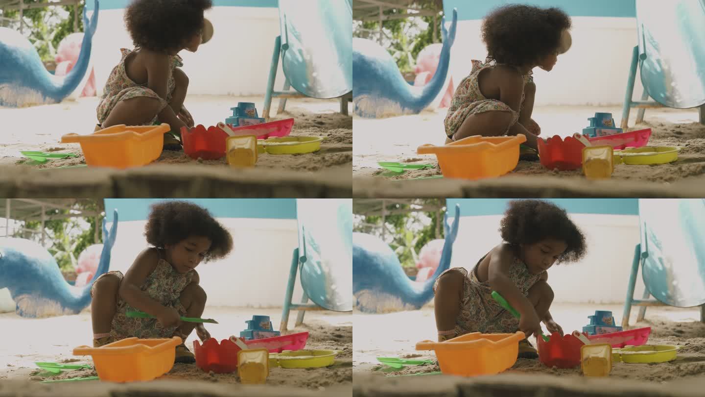 非洲女孩玩沙子。三胎二孩快乐成长大黑人儿