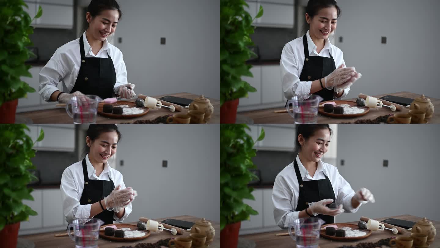 一位亚洲中国美女在厨房做中国传统的中秋雪皮月饼