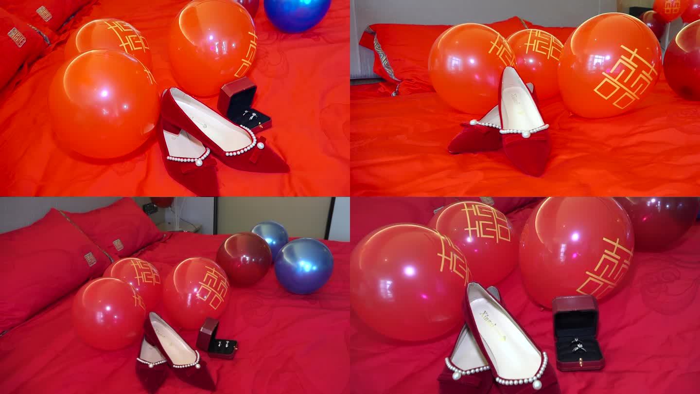 红色床单上的婚鞋戒指和红色气球