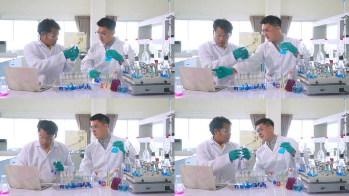 一名亚洲医学科学家小组的研究人员身穿实验服和防护设备，仔细检查、测量液体和笔记本电脑，寻找潜在的新冠