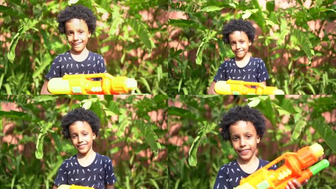 一个男孩在后院玩水枪的肖像