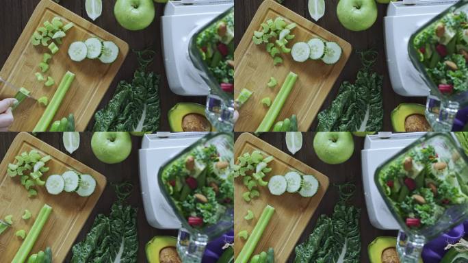 饮食理念：女性手切蔬菜排毒冰沙的镜头正下方。厨房桌子上的砧板和搅拌机