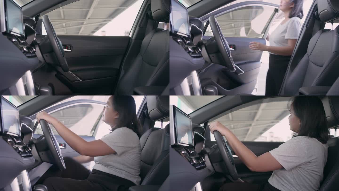 女子进入汽车驾驶员座椅并系好安全带