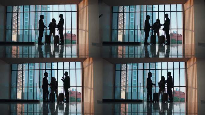 一位商人和一位女商人在一间有巨大窗户的大办公室里交谈的剪影