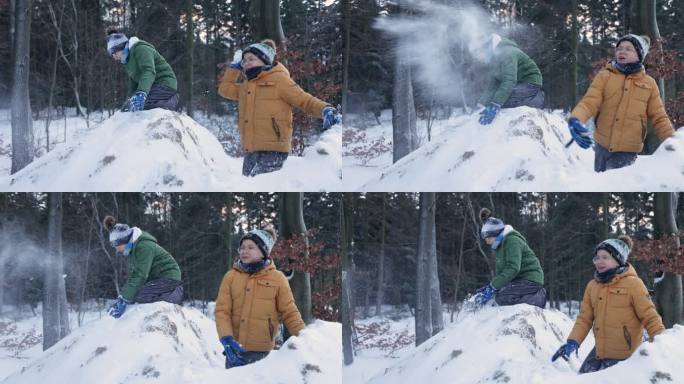 两个男孩玩雪和扔雪球