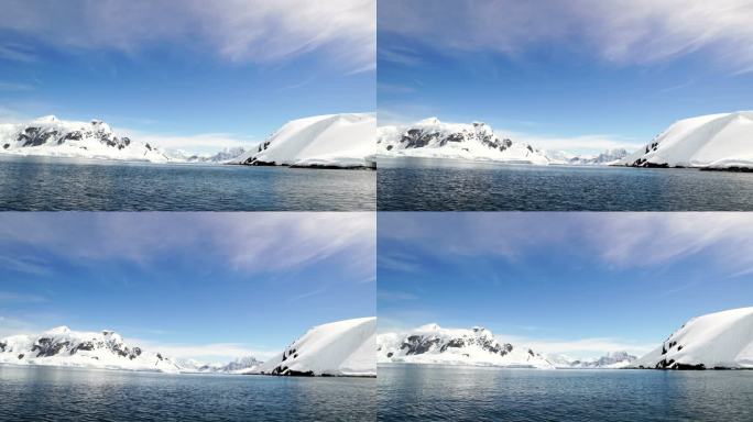 南极洲冰山间漂浮着游客的小船