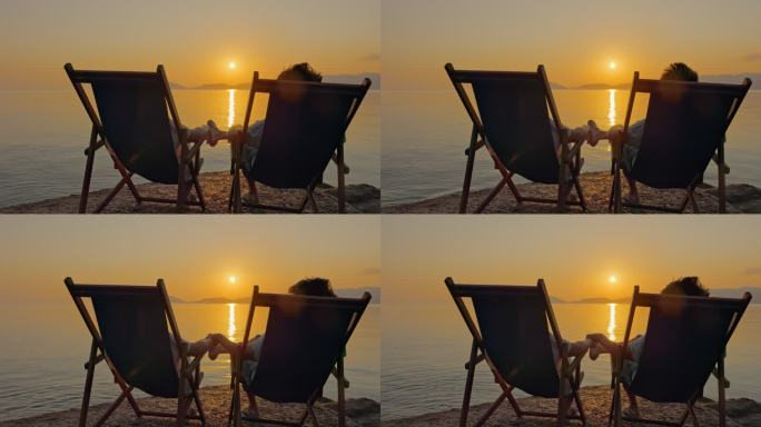 日落时分，意大利厄尔巴岛，一对夫妇在海岸边放松。
