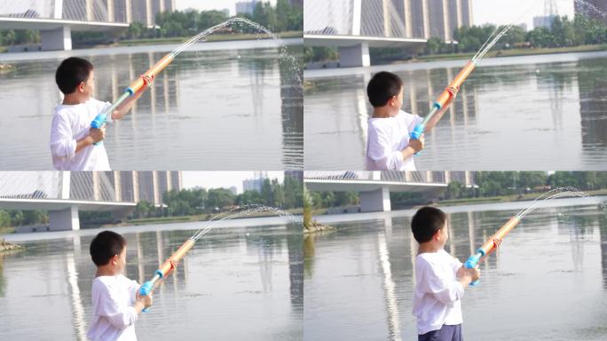 男孩在水边玩玩具水枪