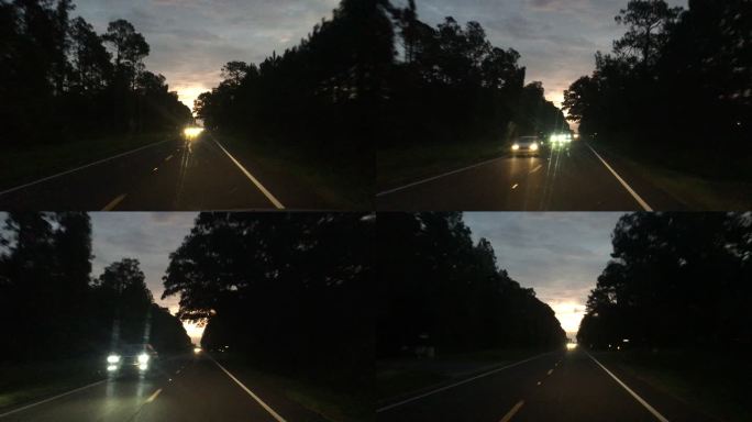 黎明前/夜间在有迎面而来车辆的农村铺面道路上行驶