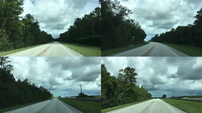 在佛罗里达州梅尔罗斯附近的一条弯弯曲曲的乡村道路上，夏日的流逝，乌云密布，右边是雨
