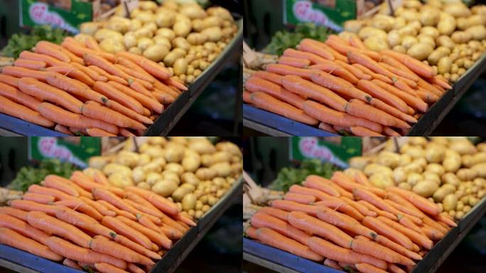市场摊位上的胡萝卜和土豆
