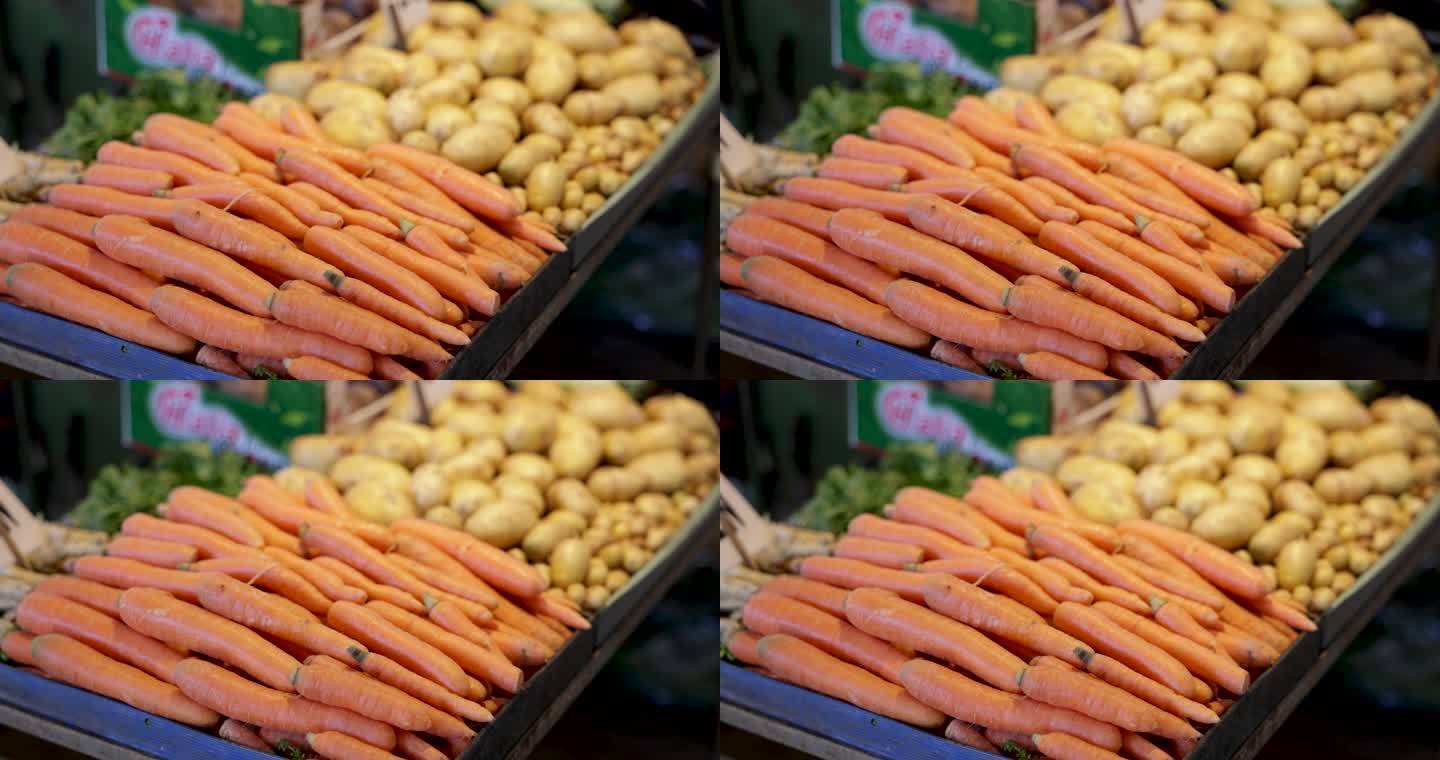 市场摊位上的胡萝卜和土豆