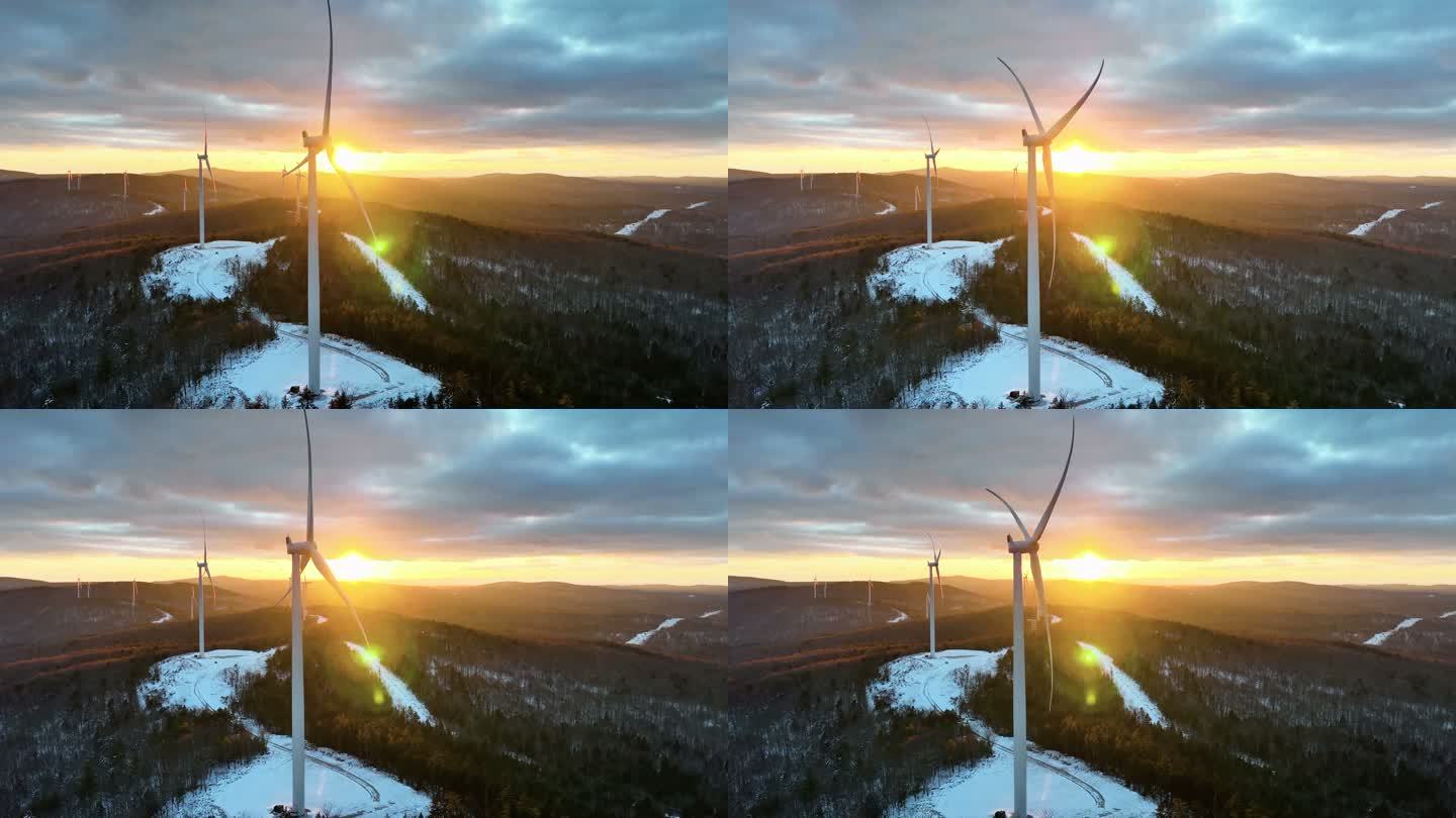 在被白雪覆盖的犹他山脉包围的日出（日落）雾蒙蒙的冬日早晨，风力涡轮机缓慢转动