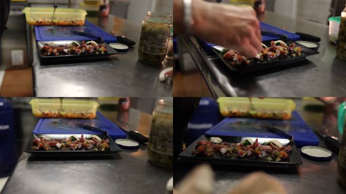 专业厨师将鱿鱼与沙丁鱼一起放在盘子里
