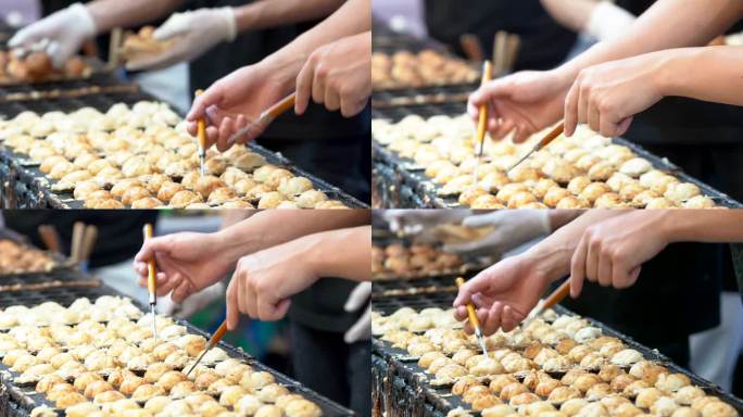 厨师们正在烹饪日本料理takoyaki，这是一种广受顾客欢迎的日本料理。