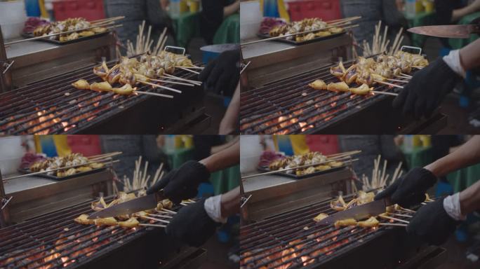 泰国曼谷耀瓦拉特的亚洲街头美食——煤炉上的烤鱿鱼特写