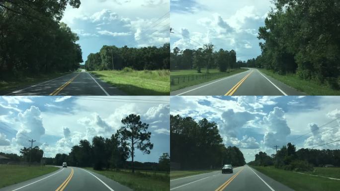 佛罗里达州米德尔堡附近蜿蜒的乡村道路变得笔直，夏季风暴云在天空中形成