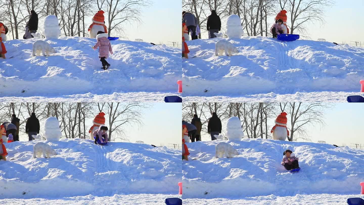 冬季滑雪场玩雪小孩从雪堆上滑下