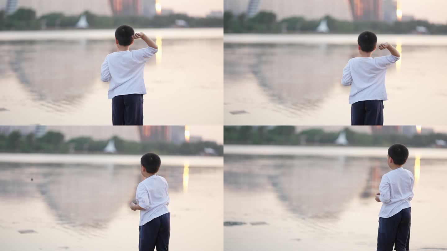 男孩快乐的向水中扔石头