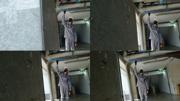 亚洲女技术员检查员检查建筑物内的管道泄漏状况。工程师女性接触
